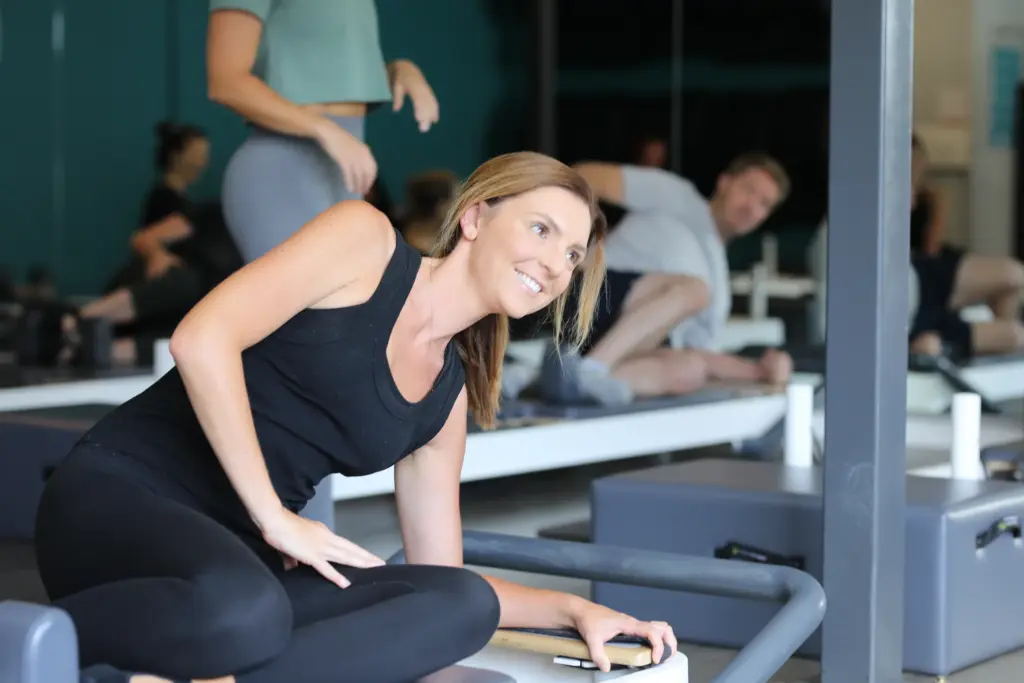 Smiling client working on the reformer